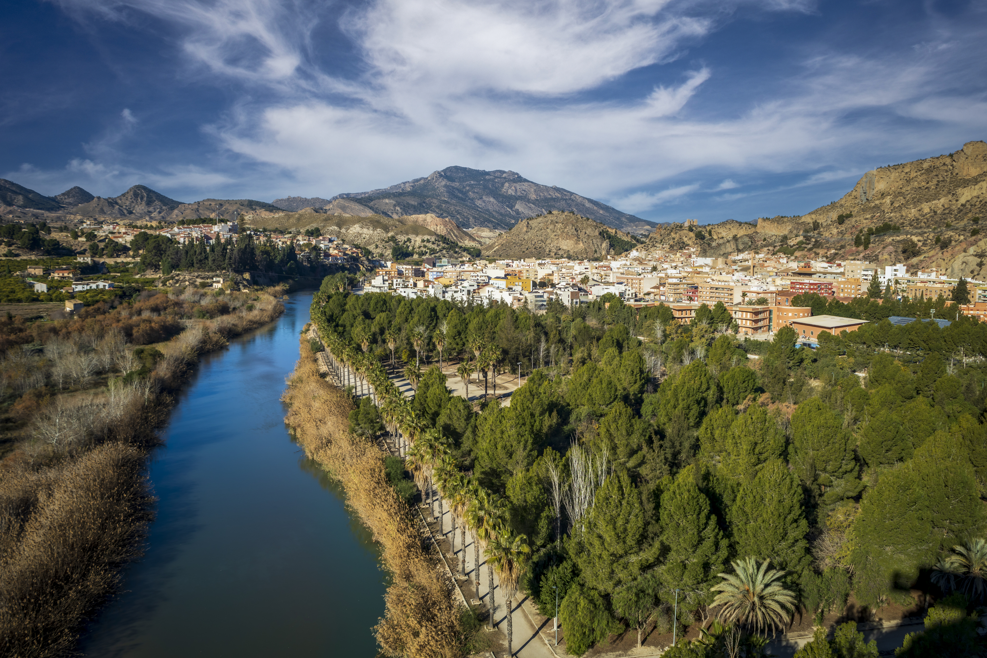 A wide view over the Segura River, green valley landscape and surrounding hills in the Ricote Valley area of Murcia.